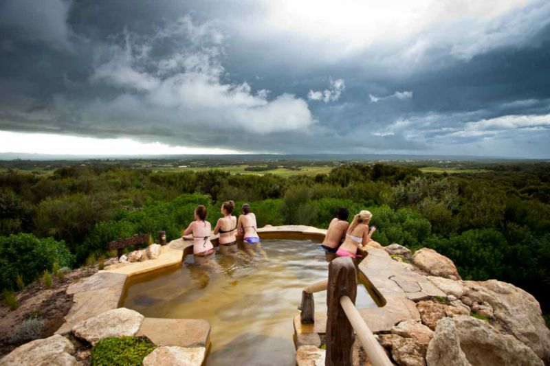 Lifestyle Enthusiast - Peninsula Hot Springs - guests enjoying top bath on hill